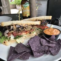 Portobello + Tempeh Bacon Sandwich w/ a side of queso at Dandelion Community Cafe in Orlando