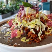 Enfrijoladas (filled with almond cheese and plátano) with vegan chorizo (made of chickpeas). at La Pitahaya Vegana in Mexico City