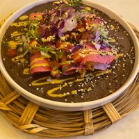 Enfrijoladas - frijoles negros cremosos sobre tortillas rosas rellenas de plátanos, almendras crocantes, requesón de coco fresco, y pico de gallo. at La Pitahaya Vegana in Mexico City