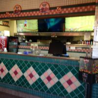 inside small - counter service with two tables at Lenzini's Pizza in North Hollywood