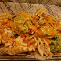 Scott's waffles - waffle fries with vegan cheese, guacamole, pico de gallo, and habanero mayo at Bareburger in Hartsdale
