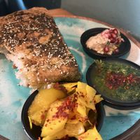 Homemade bread with zattar and dip, babaganoush and pickles. The green dip was amazing.  at Kanaan in Berlin