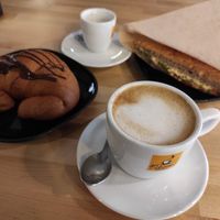 Croissant with chocolate, cappuccino, esspreso and foccacia with chickpeas cream and arugula. at Canape Incontro in Bologna