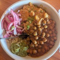 Coconut veggie korma & chana masala with pickled onions and hari mirch. at Masala in Missoula
