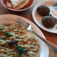 Two orders: eggplant salad (which comes with pita bread - non vegan, has milk) and side order falafel balls (which come with a non vegan, dairy based sauce) at Hummus Mediterranean Cuisine in San Mateo