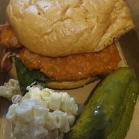 buffalo chicken sandwich with bacon macaroni salad and a pickle at The Butcher's Son in Berkeley
