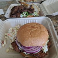 Front to back: fried chicken sandwich w/ bacon Mac salad, steak bahn mi with potato salad, and pulled pork with bacon Mac salad at The Butcher's Son in Berkeley