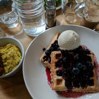 The quinoa oat and blueberry waffles with maple syrup and ice cream, "sausage," and scrambled tofu. at Mildreds - Kings Cross in North London