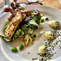 Marinated tofu with broccoli & edamame slaw, mesclun salad, miso dressing, vegan furikake, shiso microgreens, & vegan wasabi mayo at Kai Whakapai Cafe and Bar  in Wanaka