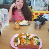 My lovely girlfriend and our piled plates at Hongming Vegetarian Food in Krabi