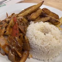 Sautéed mushrooms and vegetables with rice and chips.  at Seitan Urban Bistro in Lima