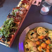 Pizza slices on a wooden board   at MADENITALY in Copenhagen