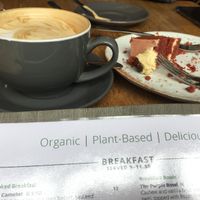 Almond milk vanilla latte and red velvet vegan cake. at Excalibur Cafe in Glastonbury