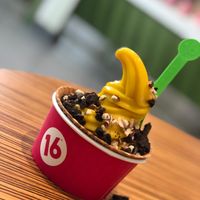 Mango sorbet with crushed Oreos, almonds, and carob chips in a cone bowl at 16 Handles in White Plains