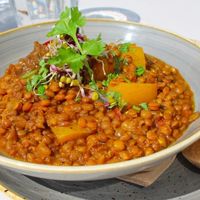 Brown lentil and yellow pepper Dahl curry with wheat free buchetta bites. at Bhuti in Richmond Upon Thames