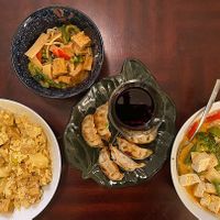 This photo is take-out on our own plates - yellow curry w/ fried tofu, red curry w/ fried tofu, veggie gyoza and panang curry w/ soft tofu. Note: they don't have rice noodles. at Bahn Thai in Tallahassee