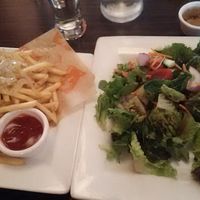 Salad with mango vinegaret and shoestring fries toped with grilled onions at Venti's Cafe and Taphouse in Salem