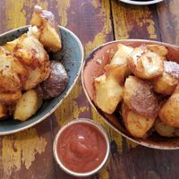 Smashed potatoes with house ketchup ~ Crunchy & delicious! at Slow Cuts in Arrowtown