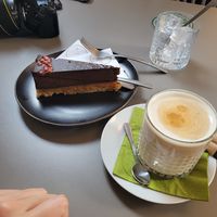 Raw pomegranate cake and iced oat latte. at Vegan's Prague in Prague