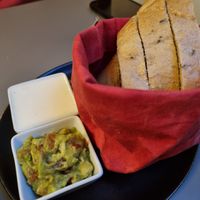 Fresh homemade bread with garlic and guacamole dips at Vegan's Prague in Prague