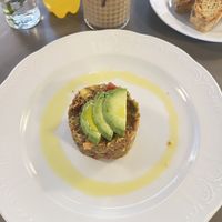 Tomato-avocado tartare with toast and garlic oil  at Vegan's Prague in Prague