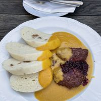 “Sirloin” with steamed yeasted dough dumplings, red berries, and root vegetable sauce   at Vegan's Prague in Prague