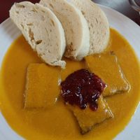 Tempeh with root veg sauce dumplings and cranberry jam at Vegan's Prague in Prague