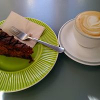 Chocolate and walnut cake, oatmilk cappuccino at Ofelia Bakery in Sevilla
