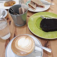 Vegan sandwich, chocolata cake, cinamon cake and capuccino with soy milk at Ofelia Bakery in Sevilla