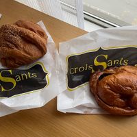 Fran left: Savoury croissant (hot dog), banana chocolate croissant,  mini plain croissant and a half chocolate dipped croissant - all vegan   at Crois-Sants in Barcelona