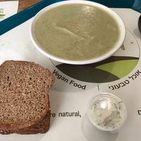 Tasty and healthy broccoli and spinach soup, big portions with 2 slices of variety of breads. at Village Green in Jerusalem
