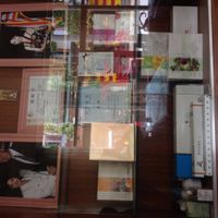 Health items for sale, plus pictures of accomplishments. at Jù Cái Sù Diàn in Tibet