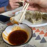 Dumplings with chilli sauce  at Jù Cái Sù Diàn in Tibet