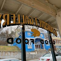 Front window sitting at cafe table?historic Roy’s Hall across the way  at Gourmet Gallery in Blairstown
