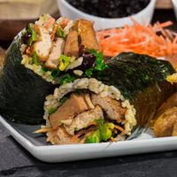 Saucy Tofu Roll: Ginger braised tofu, avocado, crispy wonton crisps, shredded carrots, organic field greens and black bean sauce at Yugo in Miami