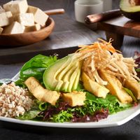 Saucy Tofu Salad: Ginger braised tofu, avocado, crispy wonton crisps, shredded carrots, organic field greens and black bean sauce at Yugo in Miami