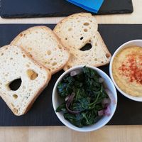 Gluten free bread available with homemade hummus and spinach at Cafe Nomad in Fuengirola