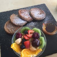 Vegan pancakes served with agave and fruit salad, Will order without sugar next time, a bit overload with the sugars. at Cafe Nomad in Fuengirola