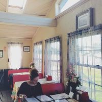 My sister sitting at one of the tables. at Oy Vey Jewish Bakery and Delicatessen in Terre Haute