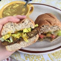 Veggie burger on a homemade bun with a side of tofu curry soup! (The sauce on this sandwich is aMAZING!) at Oy Vey Jewish Bakery and Delicatessen in Terre Haute