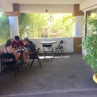 Half of the cozy outdoor space surrounded by bamboo.   at Loving Hut in Fresno