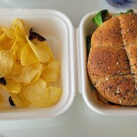Gardener burger with poppy seed bun and chips at Caju in Nice