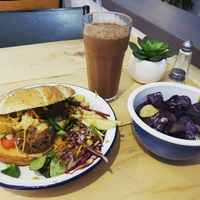 Mexican burger and cheeky monkey smoothie with blue chips at Caju in Nice