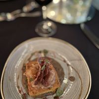 Curry, butternut squash, pumpkin seed paneer on a toasted cumin black Lentil daal finished with a garam masala apple and pear chutney topped with purple potato chips.  at Harvest Beat in Seattle