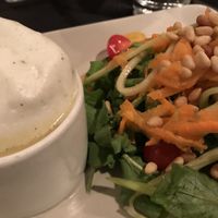 Cauliflower soup with herbal foam alongside the melon and arugula salad with julienne carrots and cucumbers topped with pine nuts at Harvest Beat in Seattle