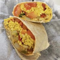 “Vegaritto” Breakfast burrito with tofu, peppers, tomatoes, potatoes, and potatoes. Sooo good!! at Bashful Banana in Ocean City