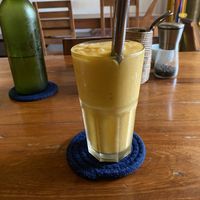 Atomic bomb smoothie and water in background  at Simple Things in Kampot