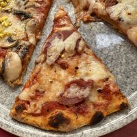 Pizza capricciosa slice at Rifugio Romano in Rome