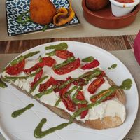 Bruschettona primosale di anacardi con pomodo confit e arancino zucca e pancetta con supplì at Rifugio Romano in Rome