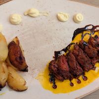 Vegetable Sliced "Meat" Served on Carrot Cream, Balsamic Vinegar Reduction Flavored with vegan mayo and potatoes at Rifugio Romano in Rome